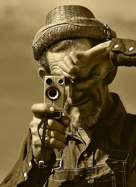 Sepia tone image of an old man with a camera