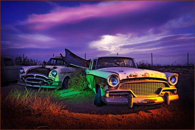 Two Classic Cars at Night