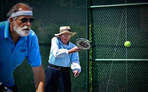 Two senior citizens in paddle tennis tournament