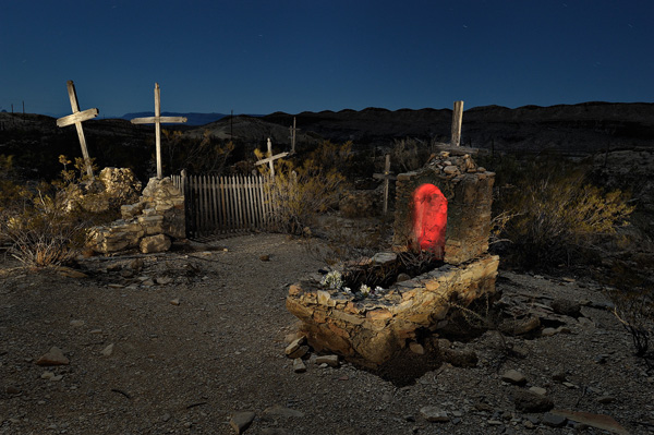 Illuminated crosses and grave site