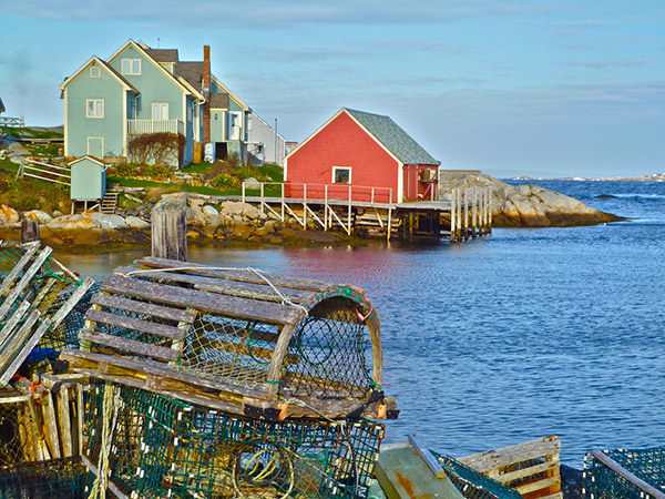 Lobster trap in foreground, water and buildings in background