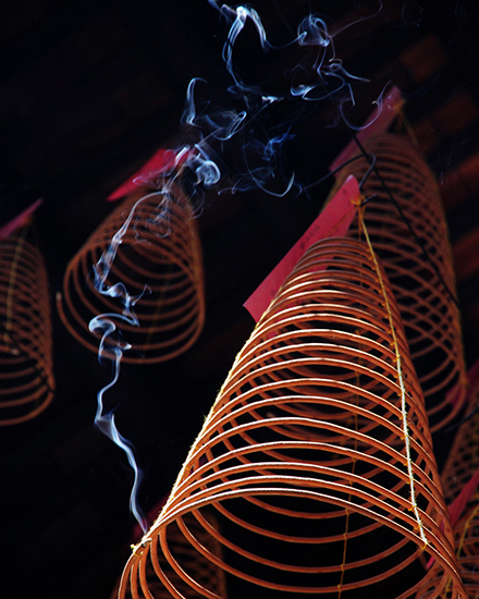 Red spiral shapes and smoke against a black background