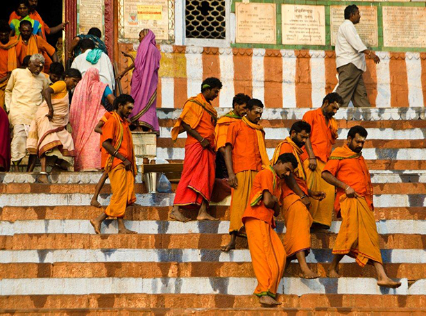 Orange Clad Pilgrims Going Down Stone Stairway