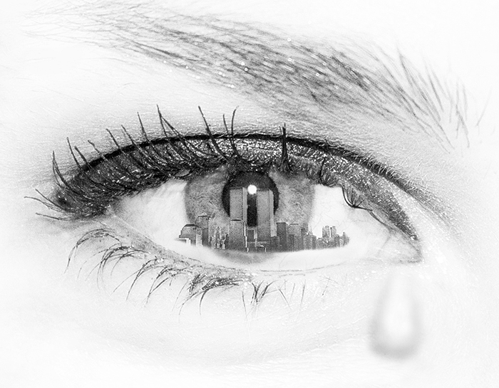 The eye of a woman with the New York skyline reflected in the iris