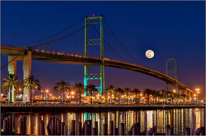Moon rising over bridge