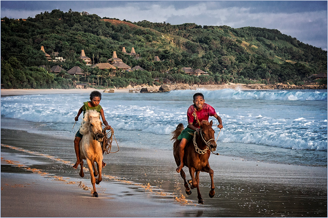 Two Boys Racing Ponies at the Surf's Edge