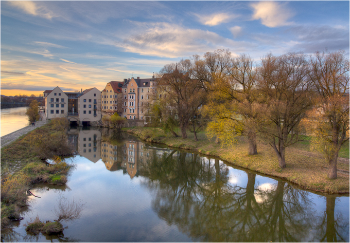 Landscape of reflections in a pond of buildings and autumn trees