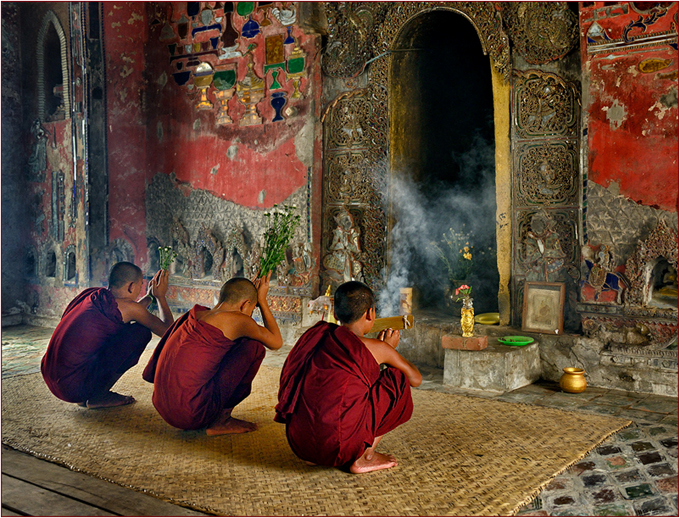 Three Buddhist novices praying